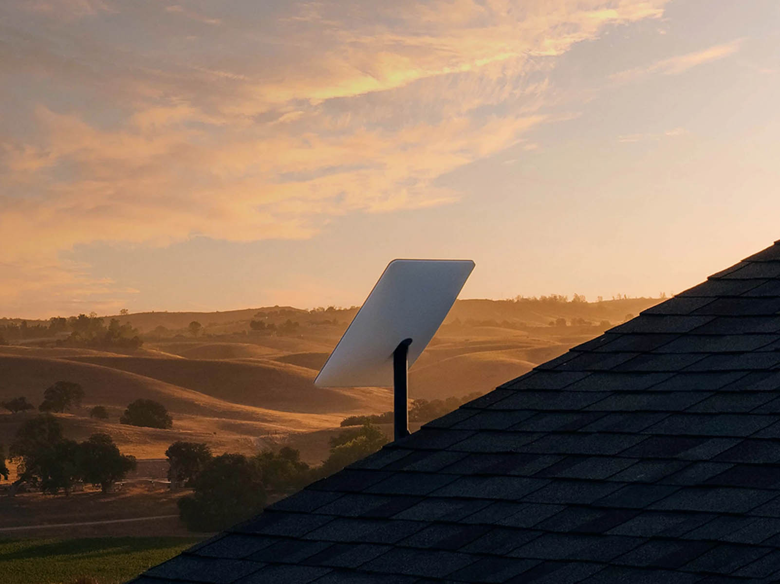Starlink satellite dish mounted on a rooftop in a rural location