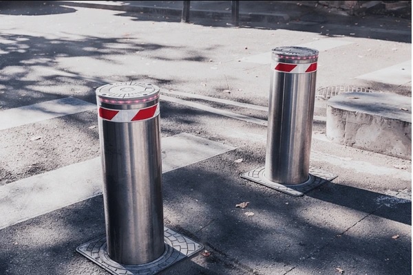 Security bollards at a car park entrance for commercial site access